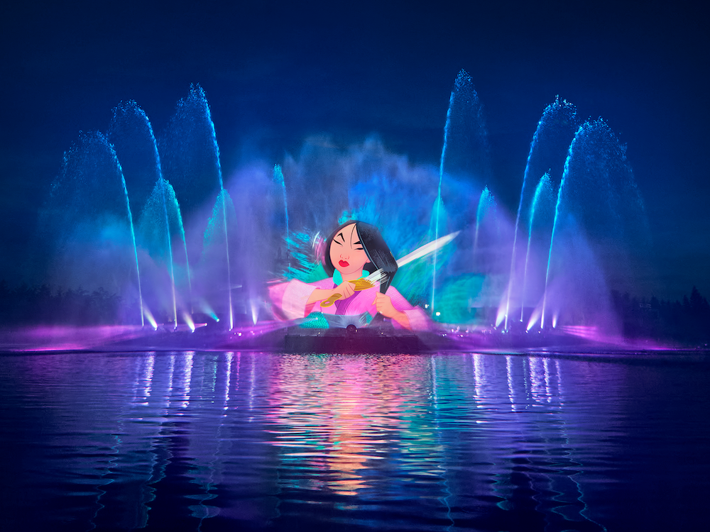 Espectáculo nocturno Disney Cascade of Lights sobre el lago Adventure Bay